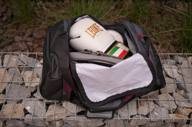 a bag with a bottle and a towel inside of it